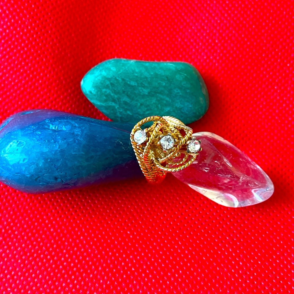 Two costume brooches and one costume ring, size seven.